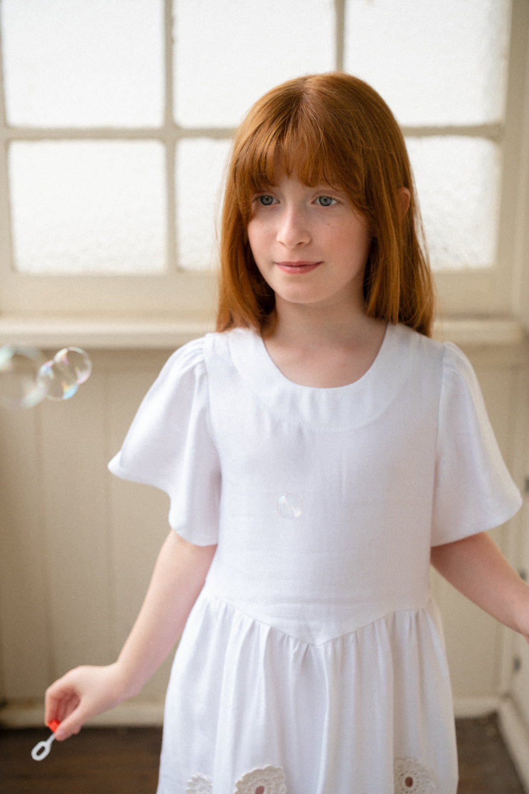 White linen dress with crocheted flowers