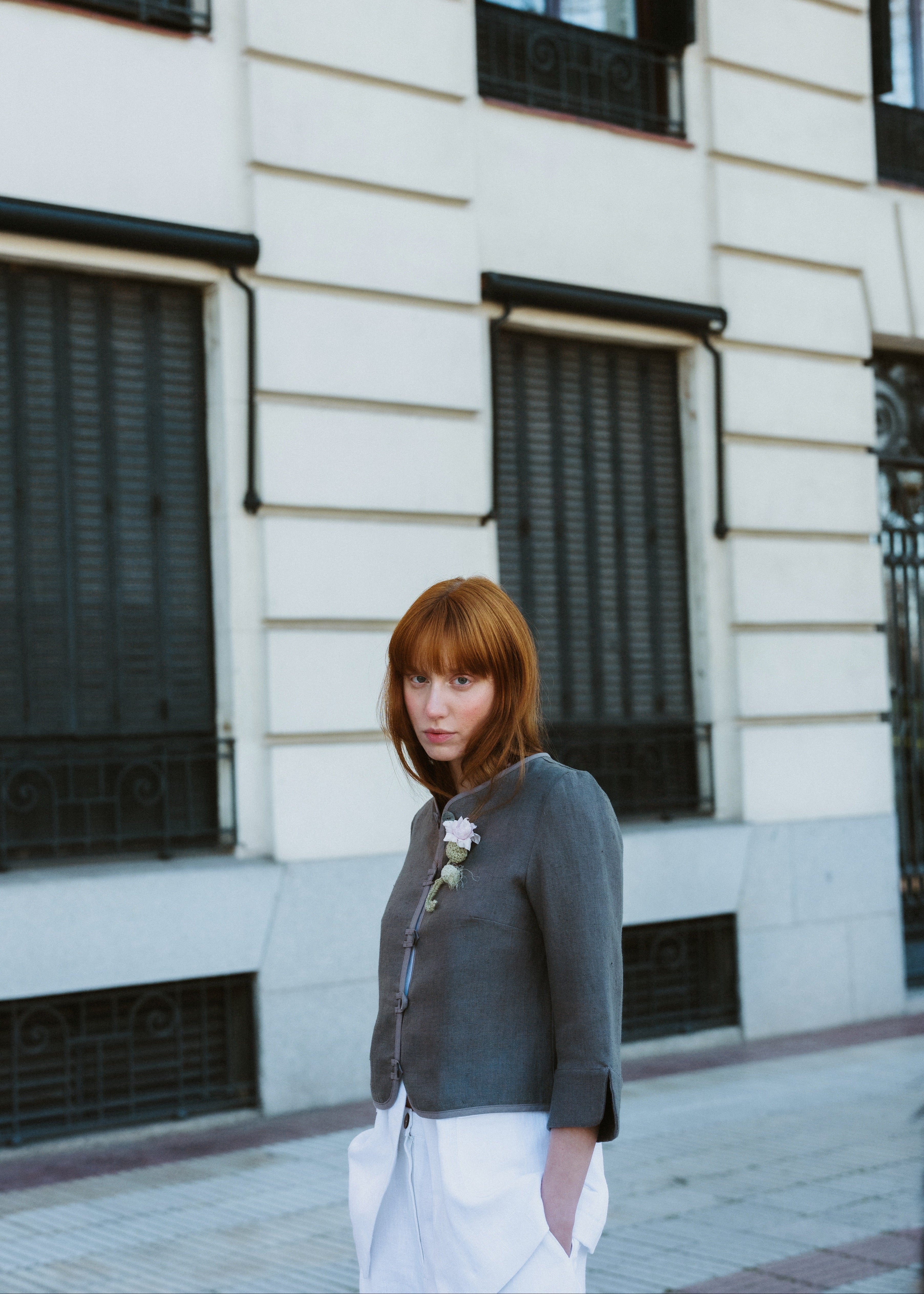 Woman standing in front of a building with large windows