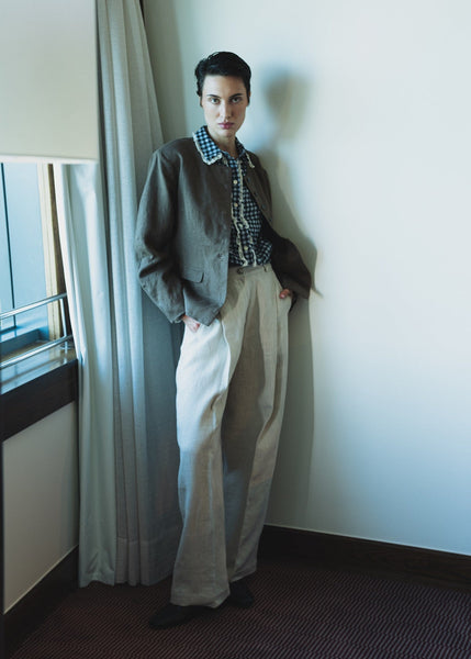 Brown jacket on a hanger against a wooden background