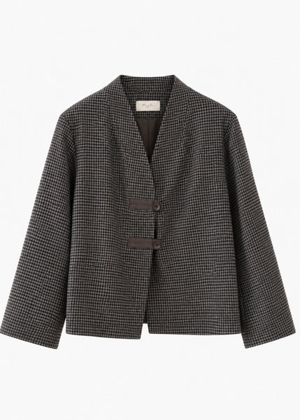 A women's long-sleeve blazer jacket featuring a fine black and white micro-check pattern, a V-neckline, and two dark brown buttons on the front, displayed against a solid white background.